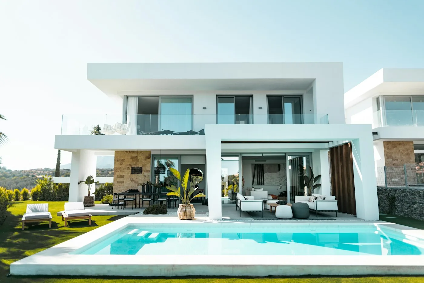 White contemporary home with pool and palms